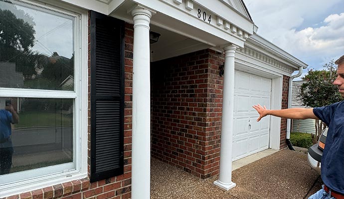 Professional inspector inspecting a house exterior Professional inspector inspecting a house exterior