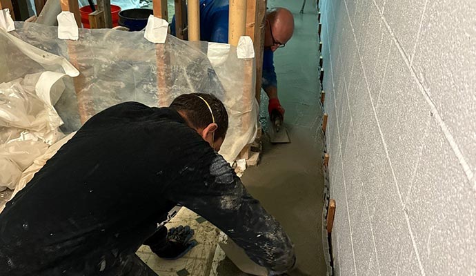 Professionals providing basement waterproofing service