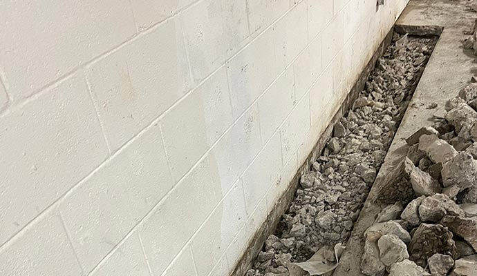 Interior drainage system installed along basement wall