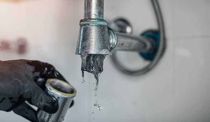 Water dripping from a disassembled drain pipe due to clogging