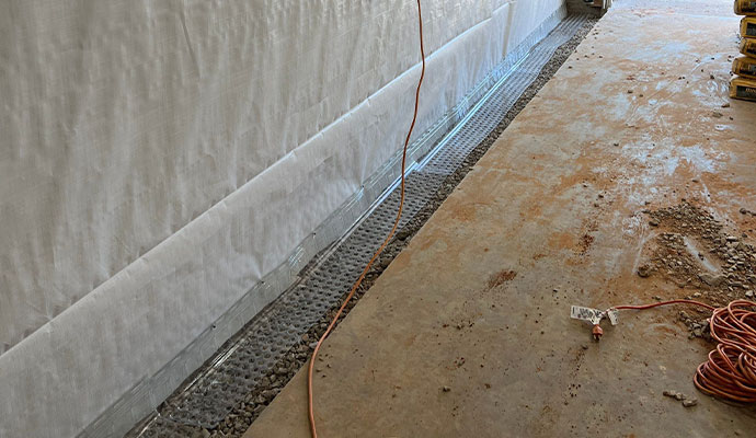 Drainage system installation for basement waterproofing