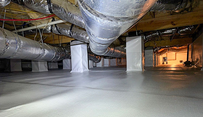 Encapsulated crawl space with vapor barrier covering floor and piers