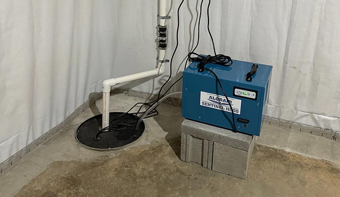 Dehumidification system installed next to a basement sump pump
