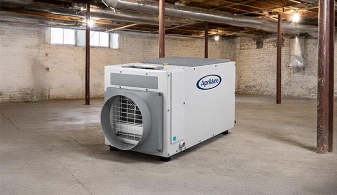 Dehumidifier placed on a concrete basement floor to control moisture and humidity