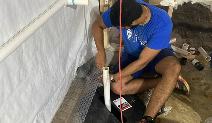 Expert repairing a sump pump system
