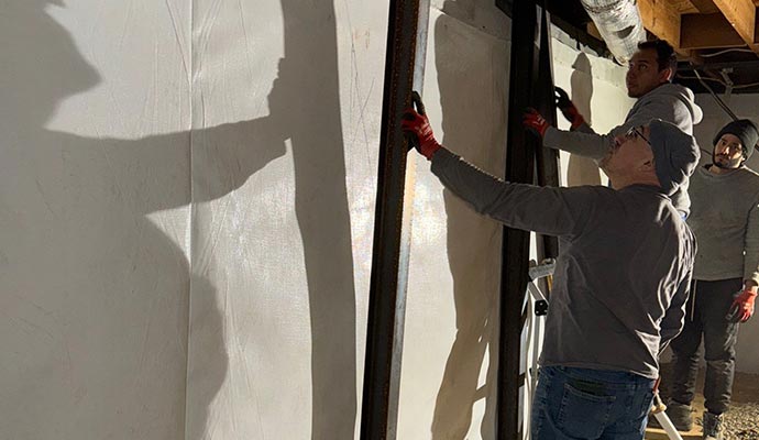 Professional team repairing a damaged foundation wall